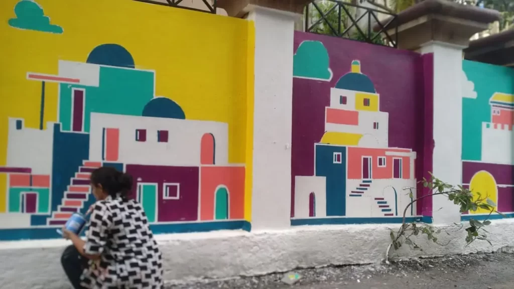 girl designing wall art for the girl hostel tribe stays at ville parle