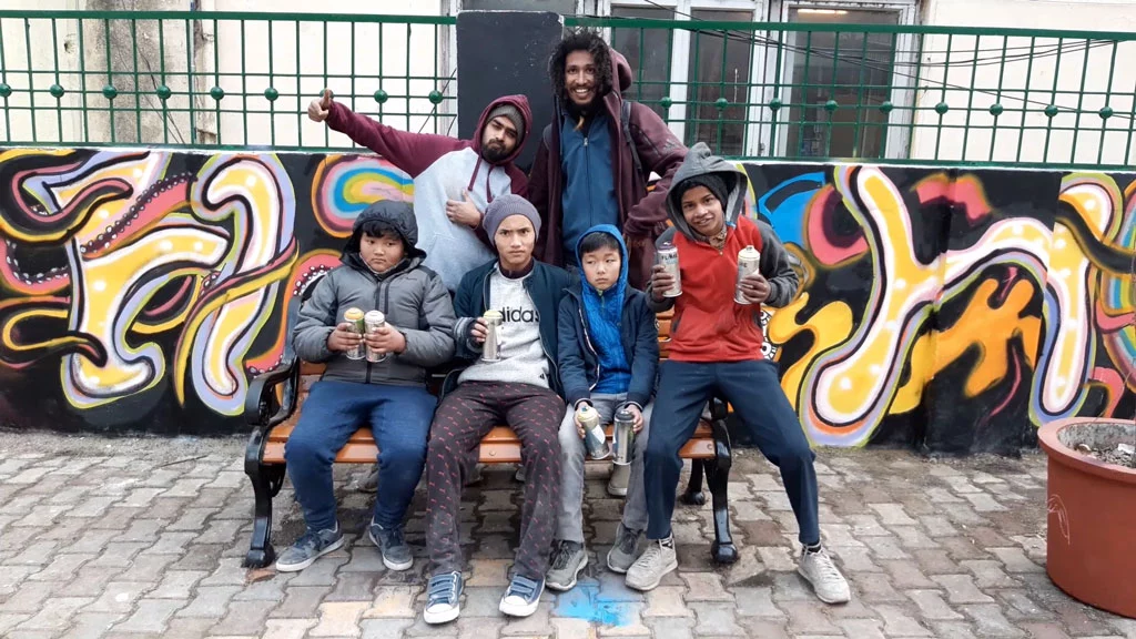 Omkar Dhareshwar and Krypt One from the Wicked Broz team with kids during a graffiti workshop in Nainital